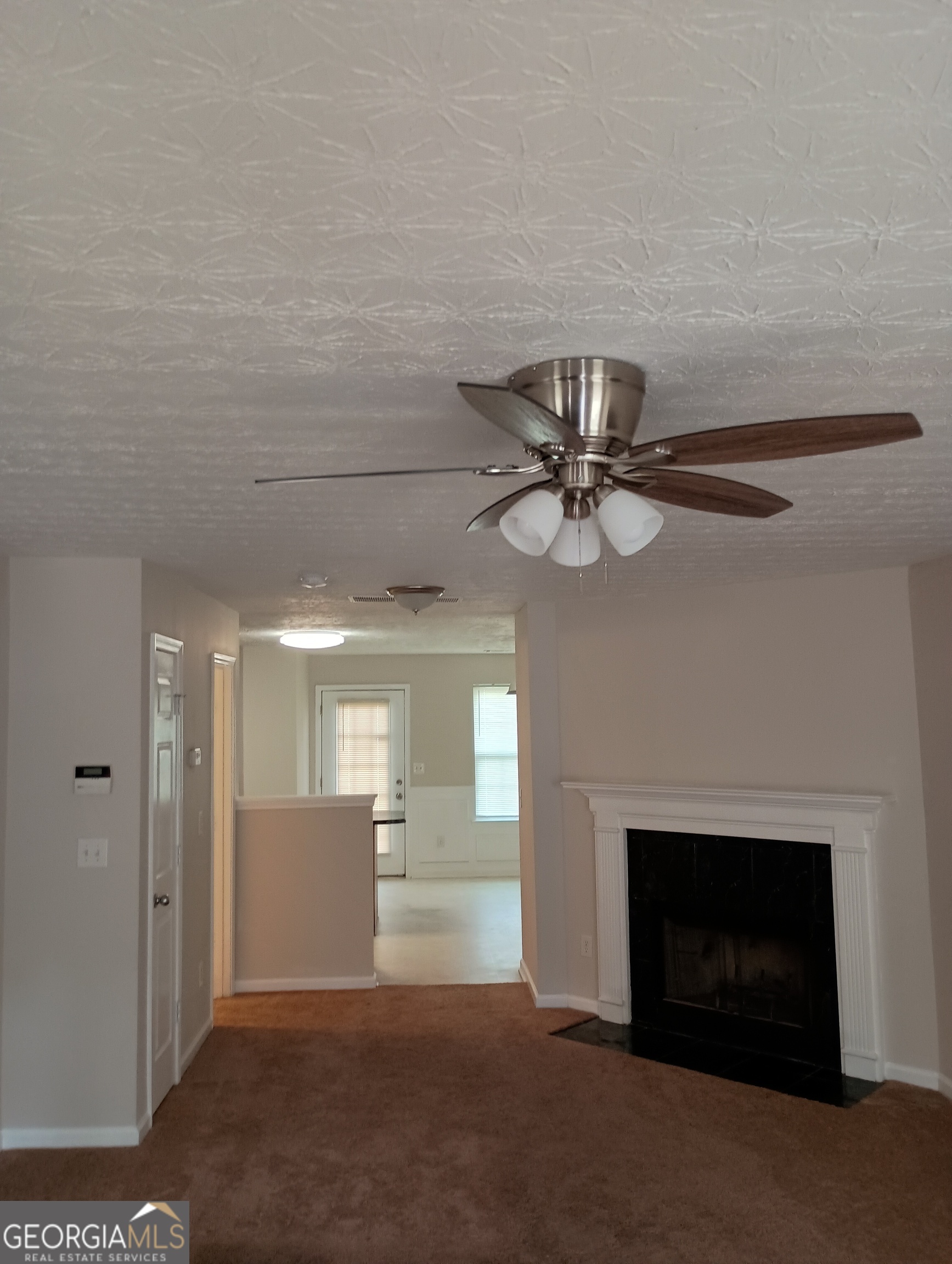2941 Vining Ridge Terrace Decatur, GA 30034 - Photo 5 of 18 a view of a livingroom with a fireplace and a chandelier fan