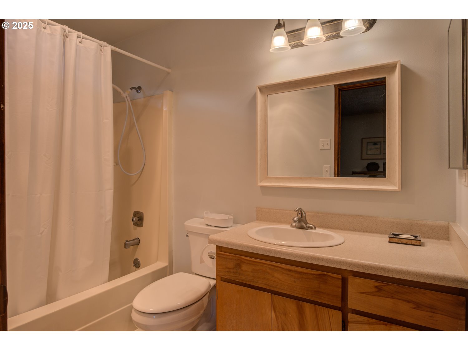 1620 26th Street Florence, OR 97439 - Photo 14 of 27 a bathroom with a sink toilet a mirror and shower curtain