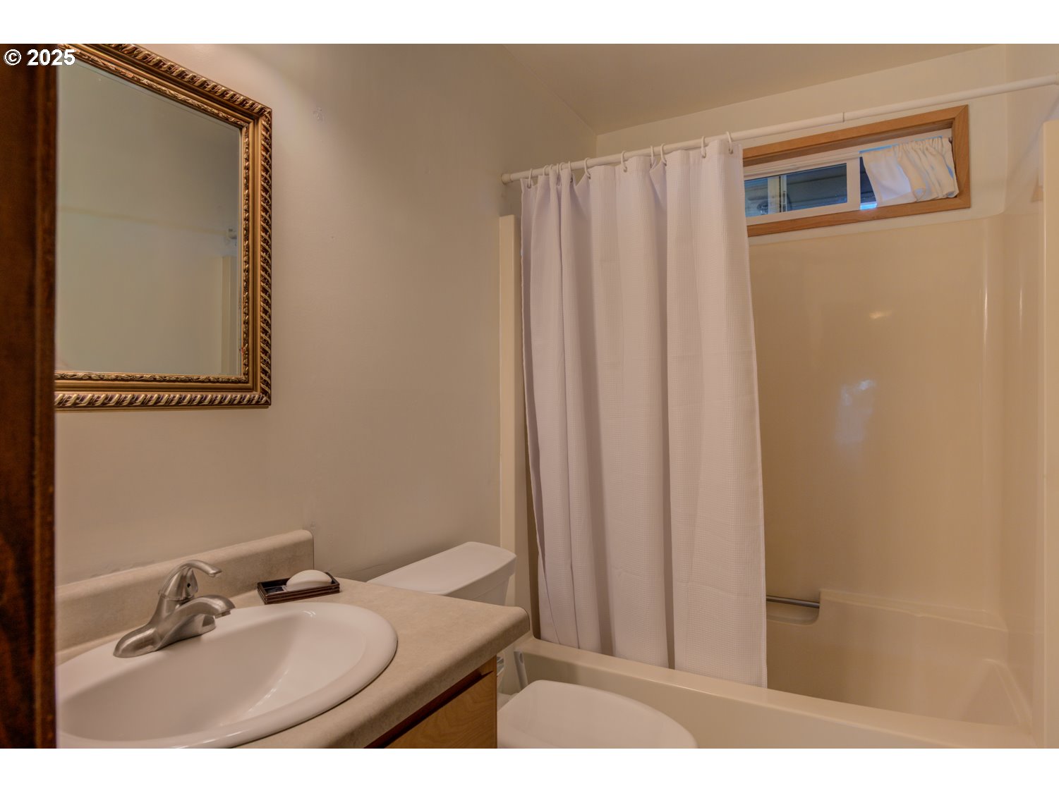 1620 26th Street Florence, OR 97439 - Photo 18 of 27 a bathroom with a sink and a mirror