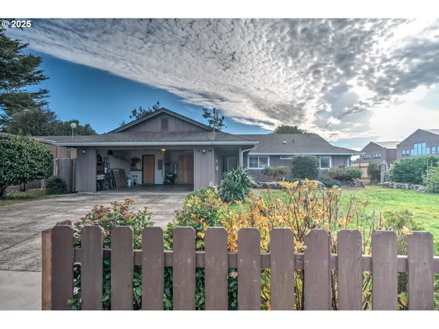 a front view of house with a garden