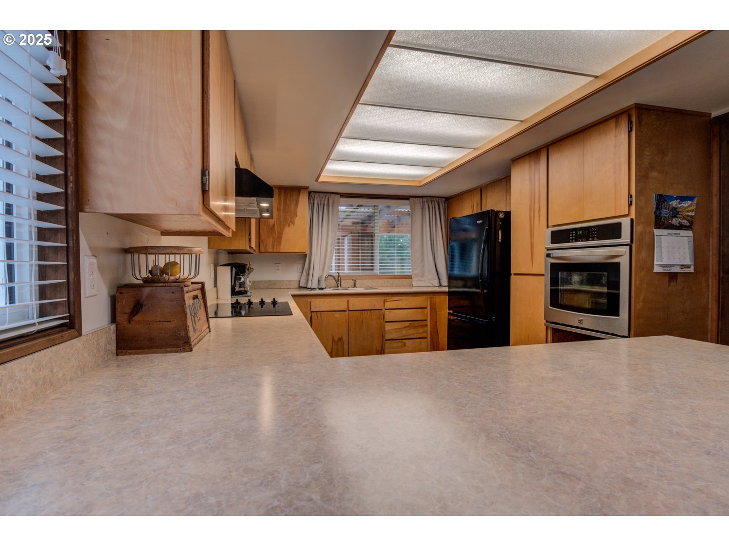 1620 26th Street Florence, OR 97439 - Photo 9 of 27 a kitchen with stainless steel appliances kitchen island granite countertop a refrigerator a stove and a sink with large cabinets