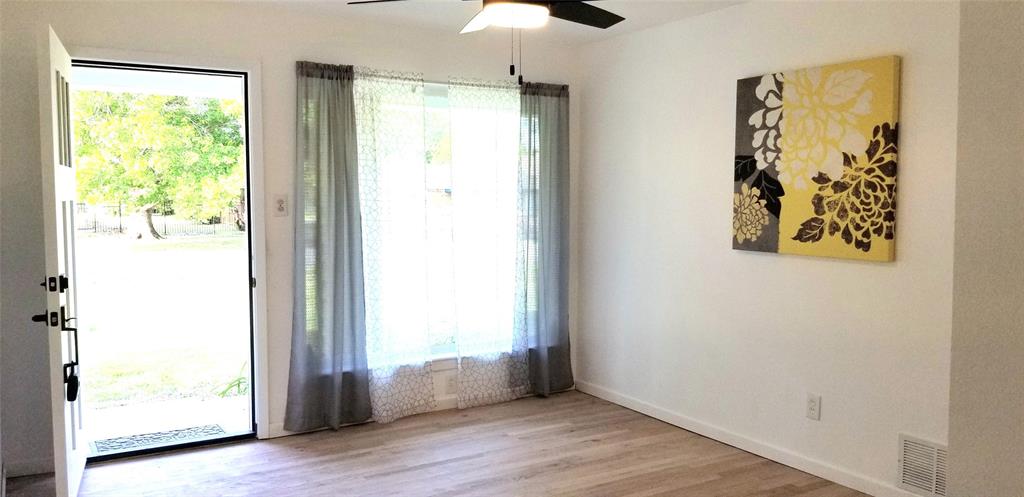 412 Ellis Street Allen, TX 75002 - Photo 22 of 36 a view of an empty room with a window and wooden floor