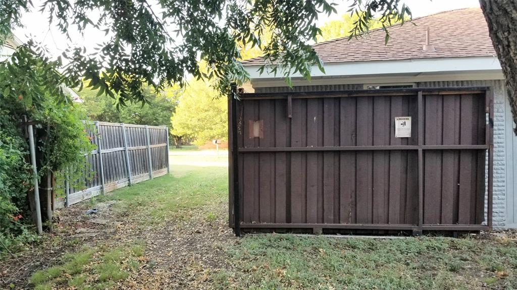 412 Ellis Street Allen, TX 75002 - Photo 32 of 36 a wooden door in front of a house with a large tree