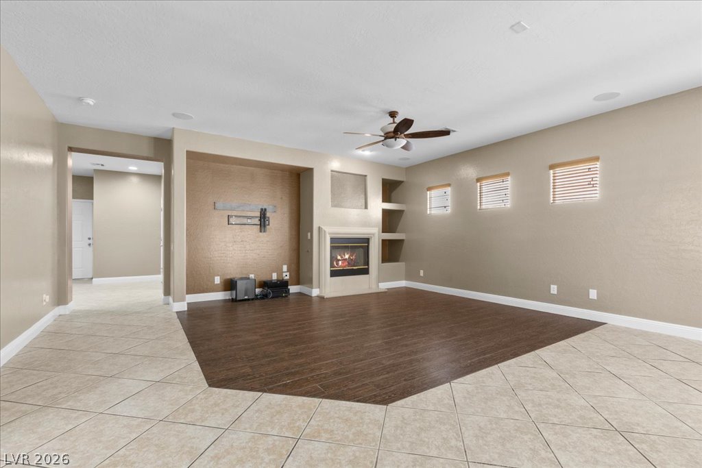 2627 Dirleton Place Henderson, NV 89044 - Photo 10 of 42 Gather around the cozy fireplace or enjoy your favorite book with built-in shelving that adds both charm and function.