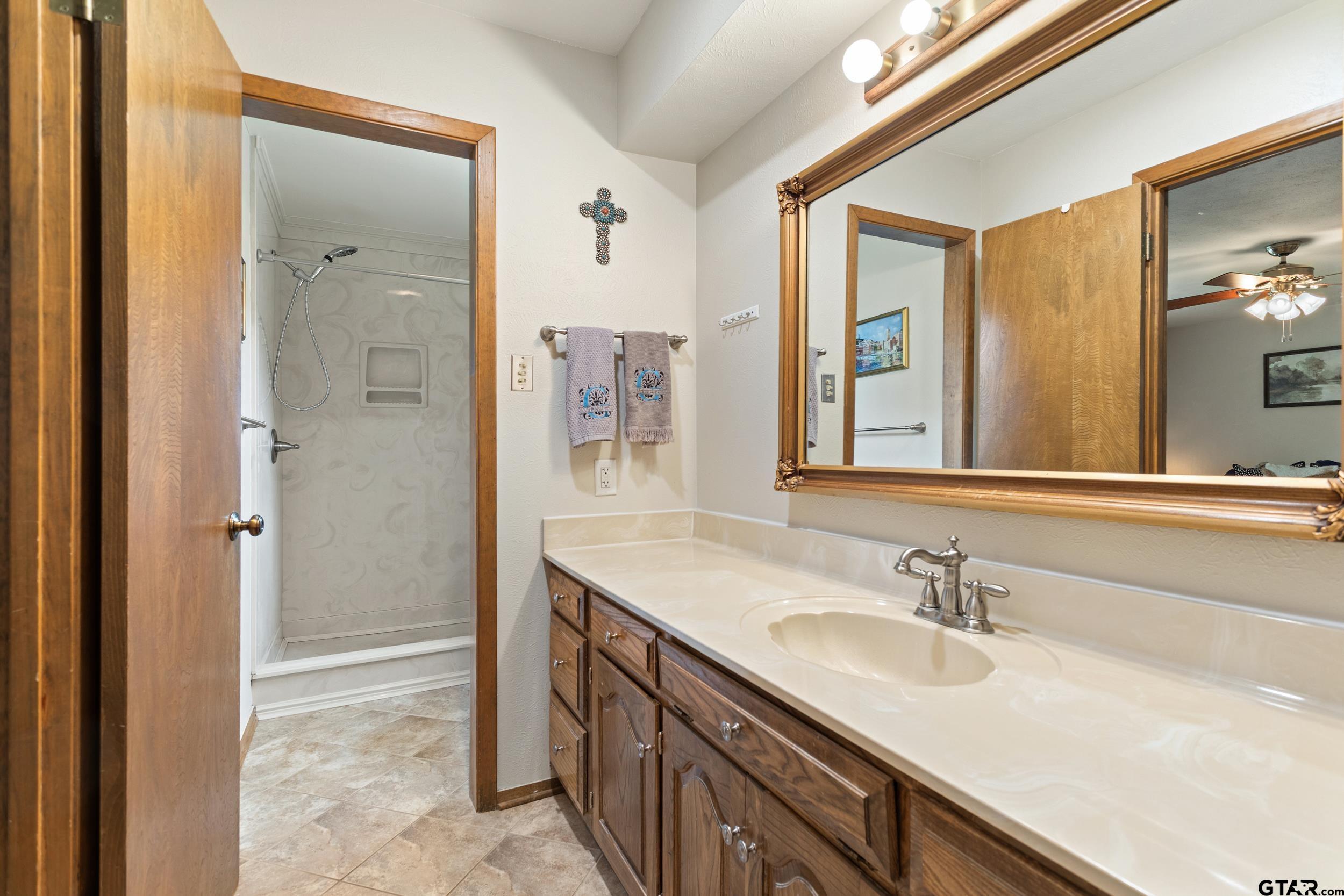 516 Ruthlynn Drive Longview, TX 75605 - Photo 24 of 34 a bathroom with a sink double vanity and a mirror