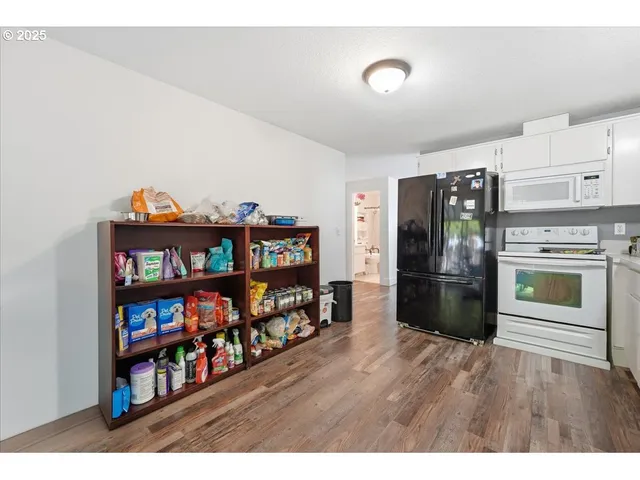a view of a workspace room with furniture and wooden floor