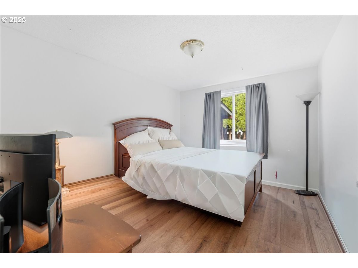 1802 Northwest 3rd Street Battle Ground, WA 98604 - Photo 13 of 16 a bedroom with a bed and a painting on the wall