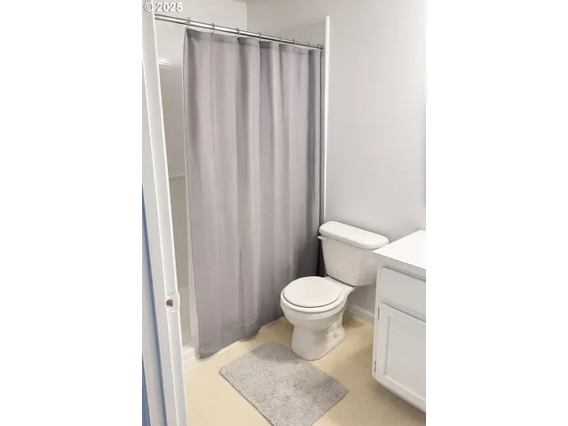 a bathroom with a toilet a sink and a shower