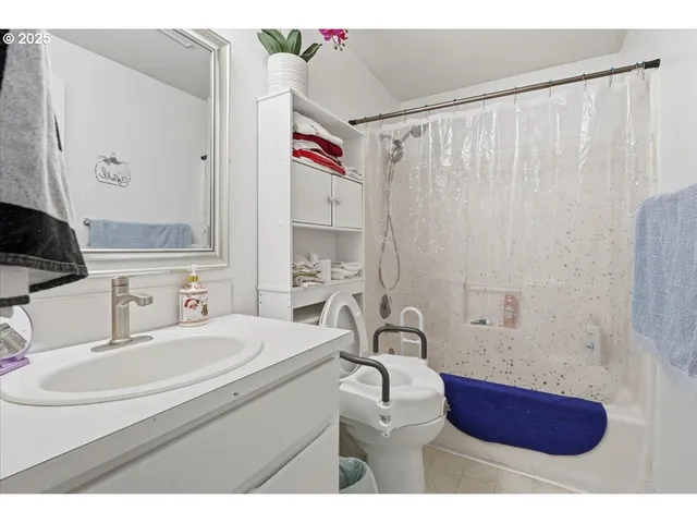 a bathroom with a sink a toilet and shower curtain