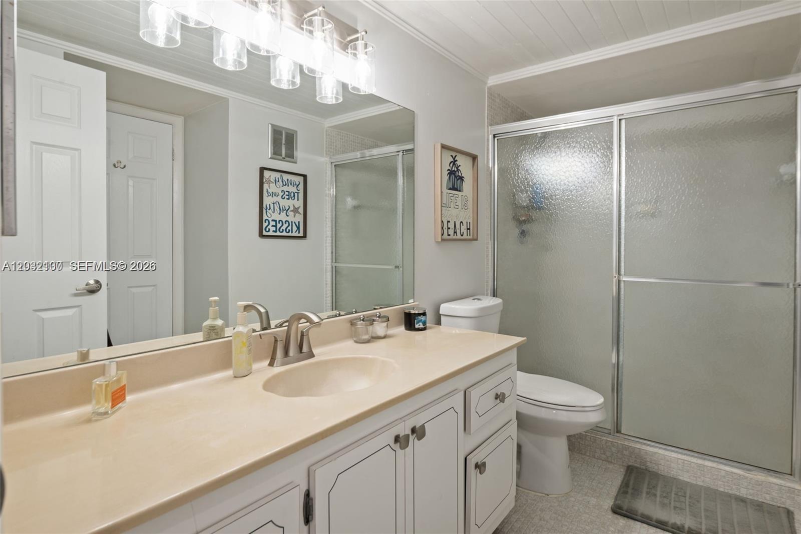 301 Racquet Club Road, Unit 104 Weston, FL 33326 - Photo 12 of 21 a bathroom with a sink a toilet a large mirror and shower