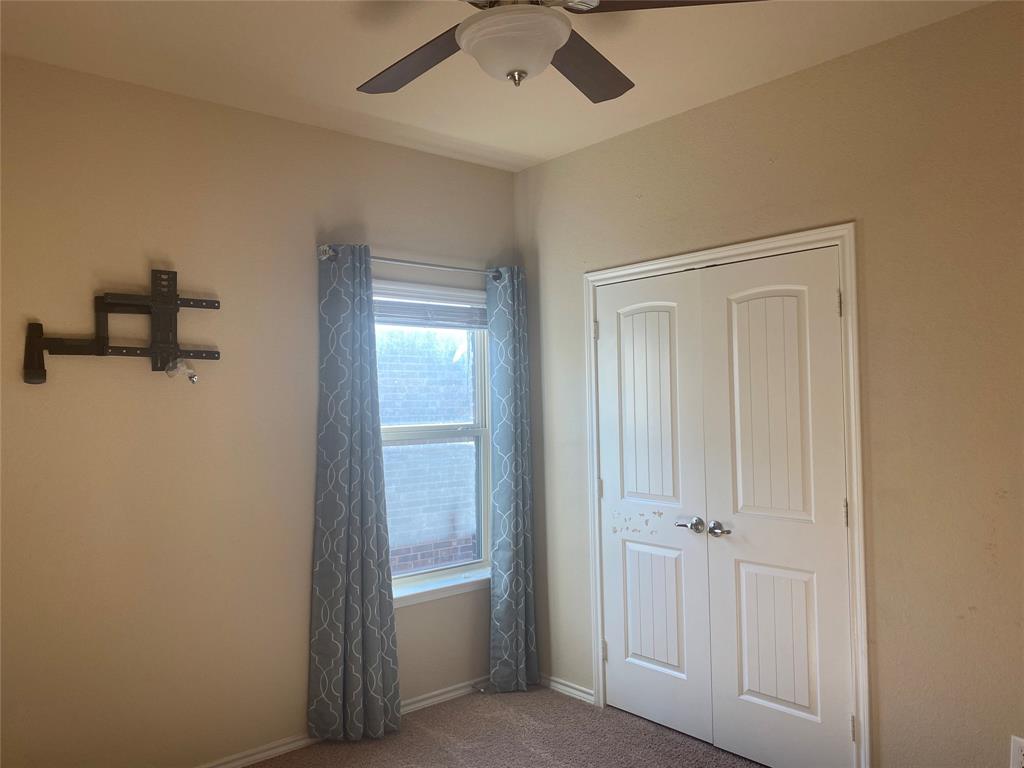 1220 Scott Drive Weatherford, TX 76087 - Photo 22 of 35 bedroom with ceiling fan and wall mount.