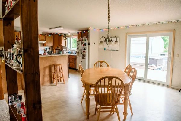 a kitchen with granite countertop a sink a counter top space and cabinets