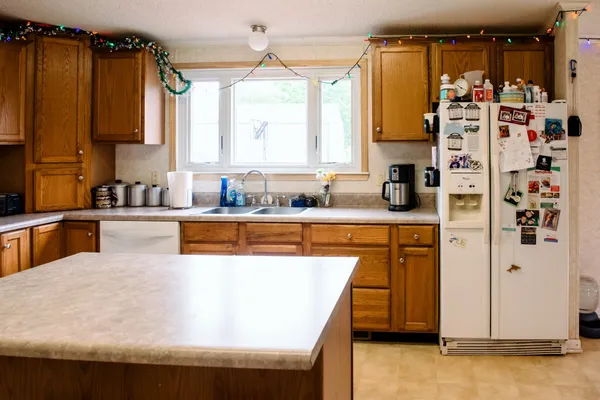 a kitchen with a sink a stove and chairs