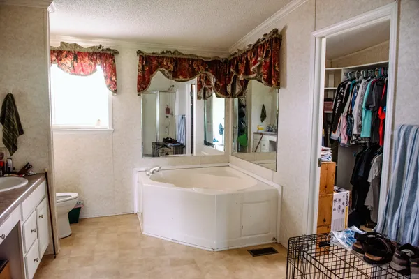 a bed sitting in a bedroom next to a window