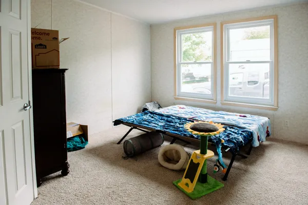 a bedroom with bed and a window