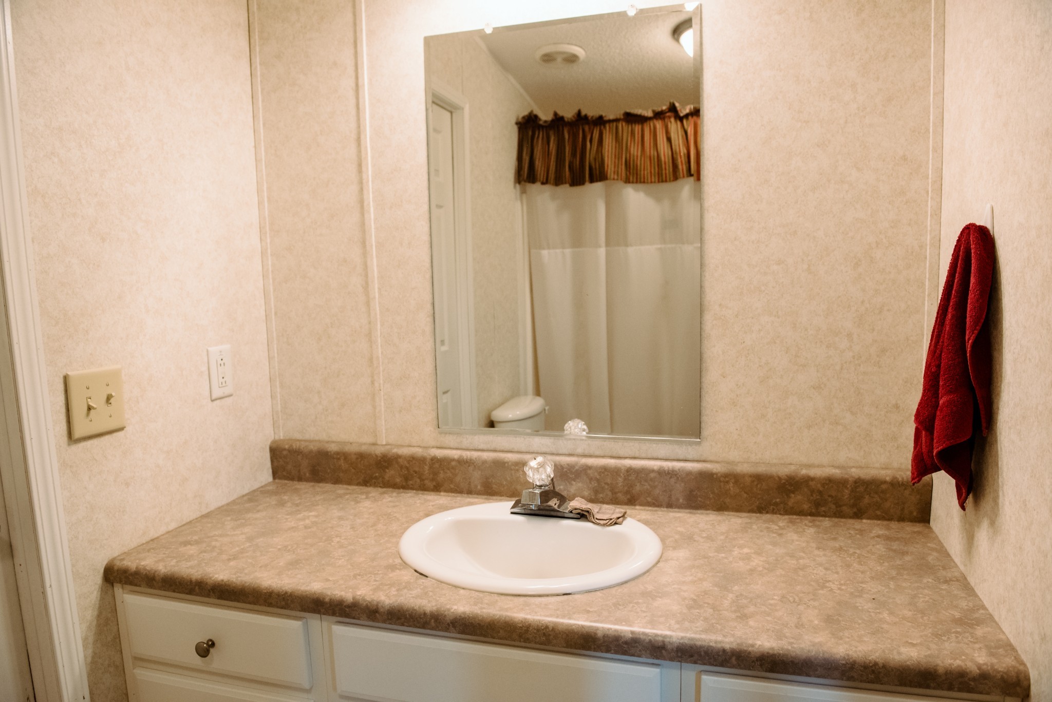 417 Buttermilk Hollow Road Bethpage, TN 37022 - Photo 28 of 33 a bathroom with a granite countertop sink and a mirror