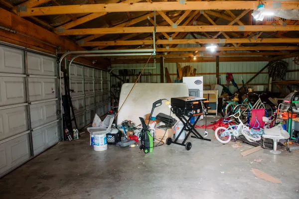 a front view of a house with yard and green space