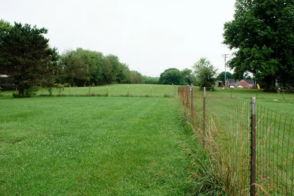 a view of a house with pool and a yard