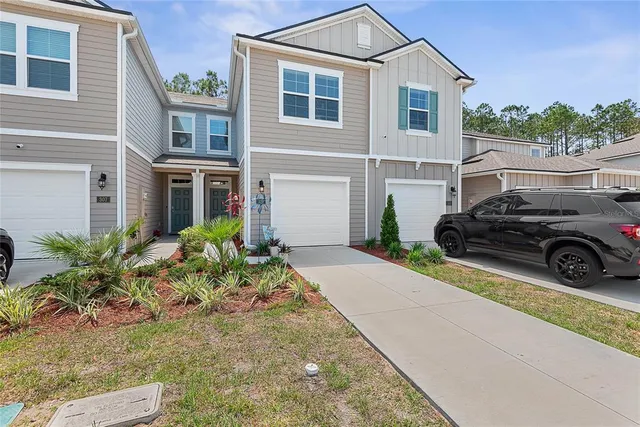 a view of a car parked in front of a house