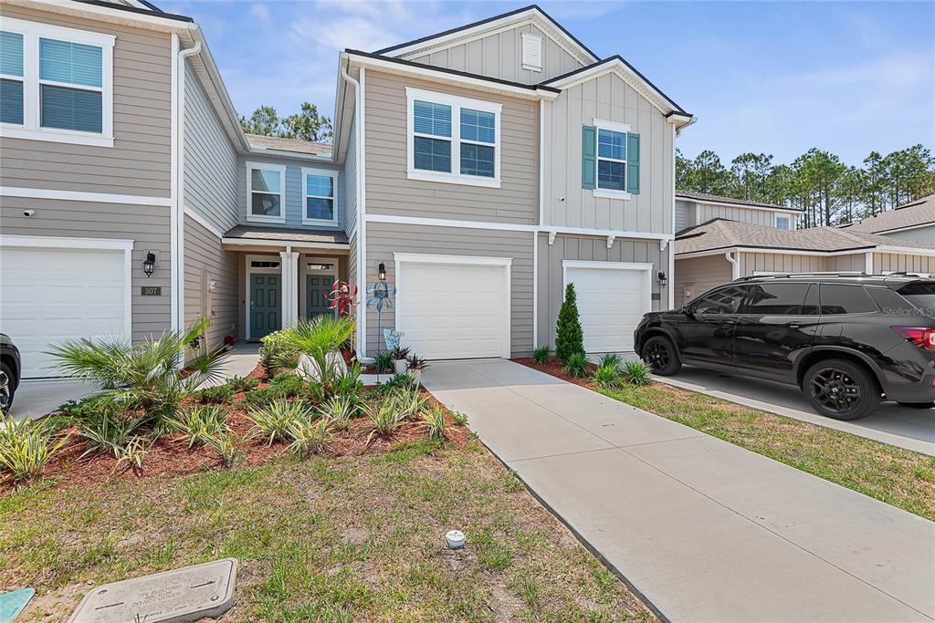 a view of a car parked in front of a house