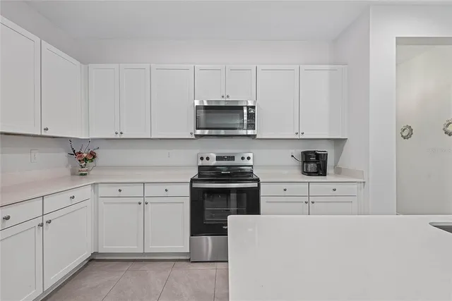 a kitchen with cabinets appliances a sink and a counter space