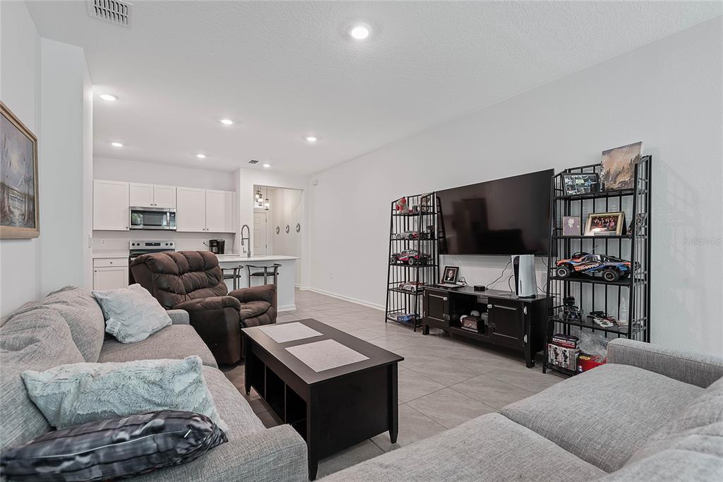 309 Redbud Road Palm Coast, FL 32137 - Photo 14 of 33 a living room with furniture and a flat screen tv