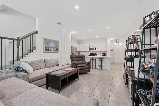 a living room with furniture and a book shelf