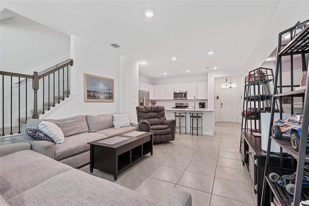 309 Redbud Road Palm Coast, FL 32137 - Photo 15 of 33 a living room with furniture and a book shelf