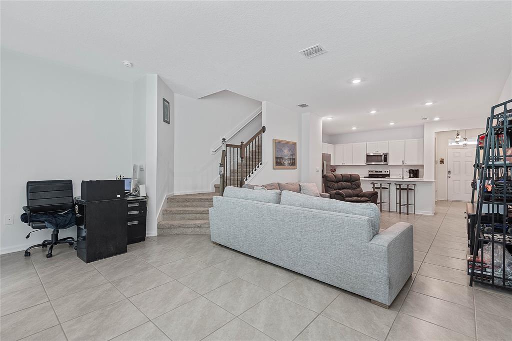 309 Redbud Road Palm Coast, FL 32137 - Photo 16 of 33 a living room with furniture and a flat screen tv