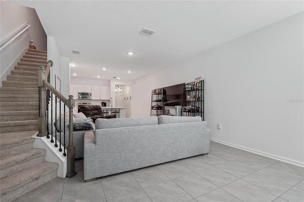 309 Redbud Road Palm Coast, FL 32137 - Photo 17 of 33 a living room with furniture and a flat screen tv