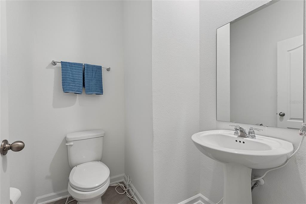 309 Redbud Road Palm Coast, FL 32137 - Photo 18 of 33 a bathroom with a toilet sink and mirror