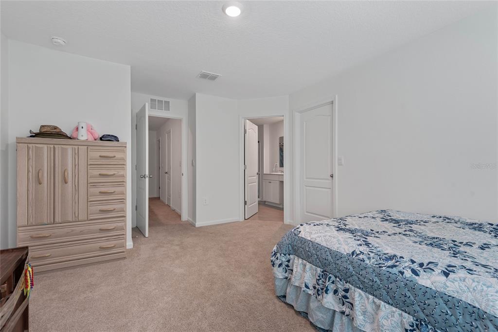 309 Redbud Road Palm Coast, FL 32137 - Photo 21 of 33 a bedroom with a bed and a cabinets