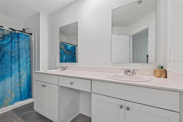 a bathroom with a double vanity sink mirror and double