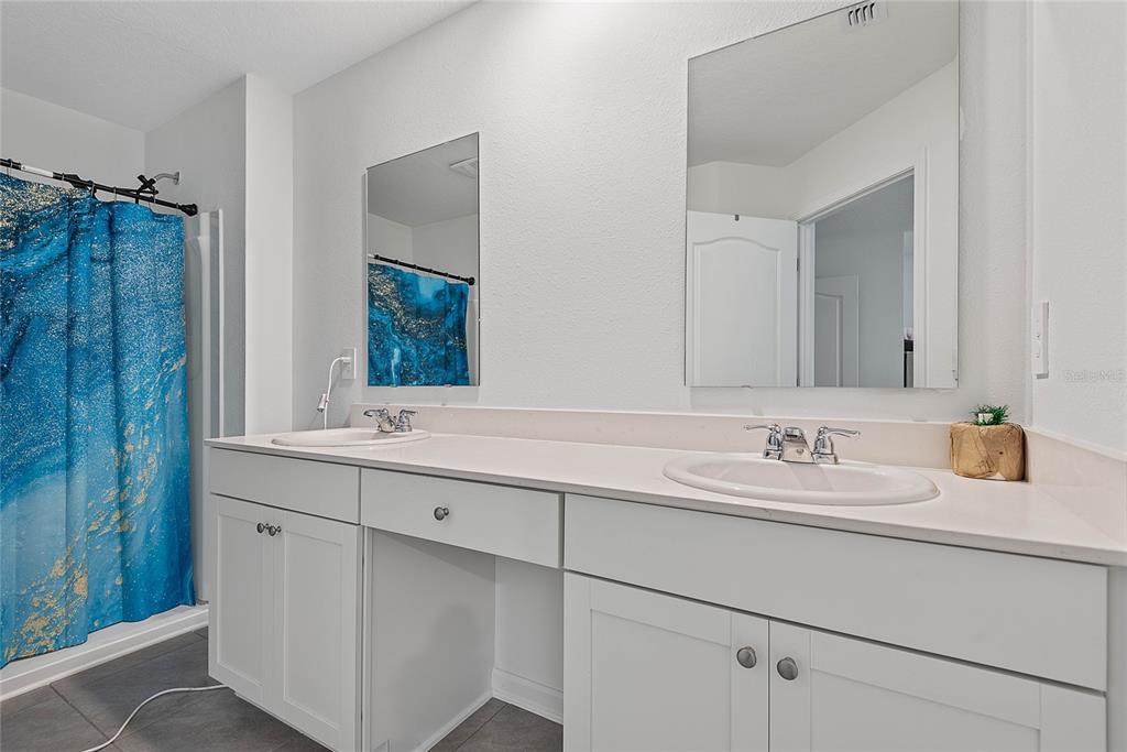 309 Redbud Road Palm Coast, FL 32137 - Photo 22 of 33 a bathroom with a double vanity sink mirror and double