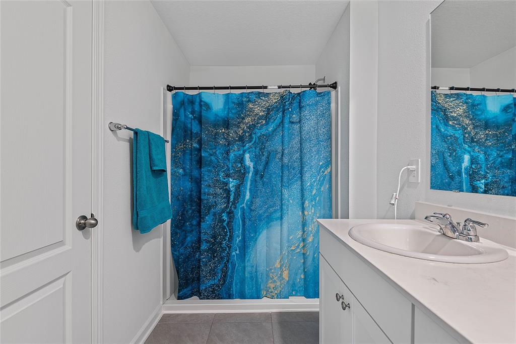 309 Redbud Road Palm Coast, FL 32137 - Photo 23 of 33 a bathroom with a sink and a mirror