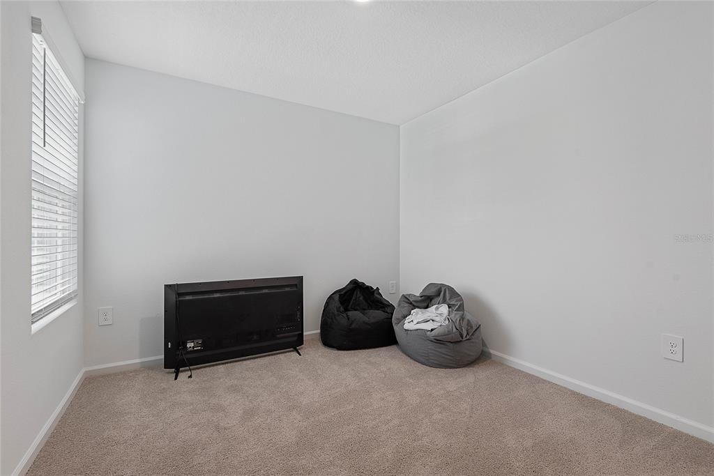 309 Redbud Road Palm Coast, FL 32137 - Photo 24 of 33 a room with a bed and a window