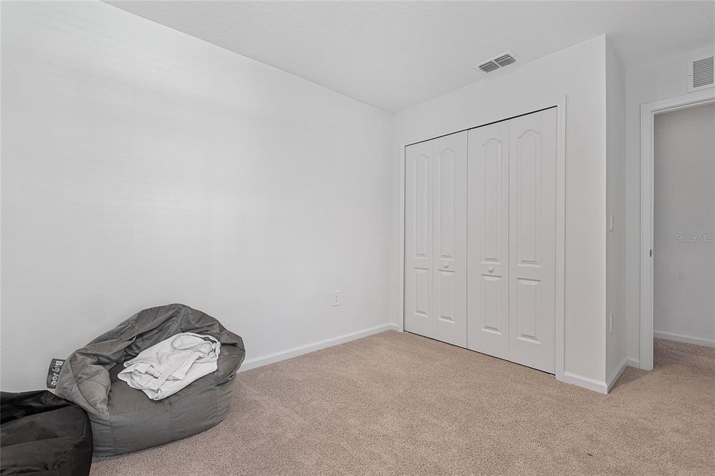 309 Redbud Road Palm Coast, FL 32137 - Photo 25 of 33 a living room with furniture and a window