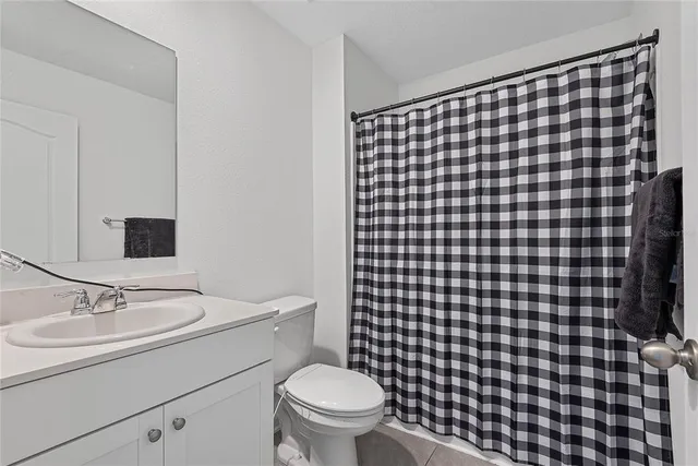 a bathroom with a sink toilet and a mirror