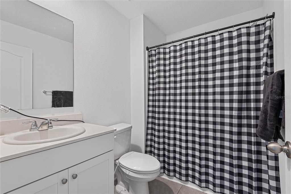 309 Redbud Road Palm Coast, FL 32137 - Photo 26 of 33 a bathroom with a sink toilet and a mirror