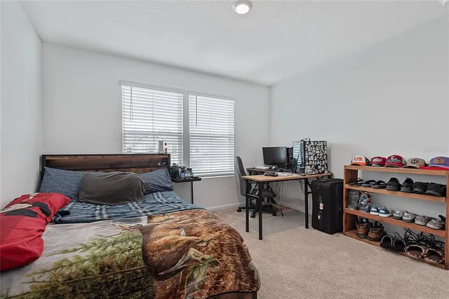 a bedroom with a bed and a desk