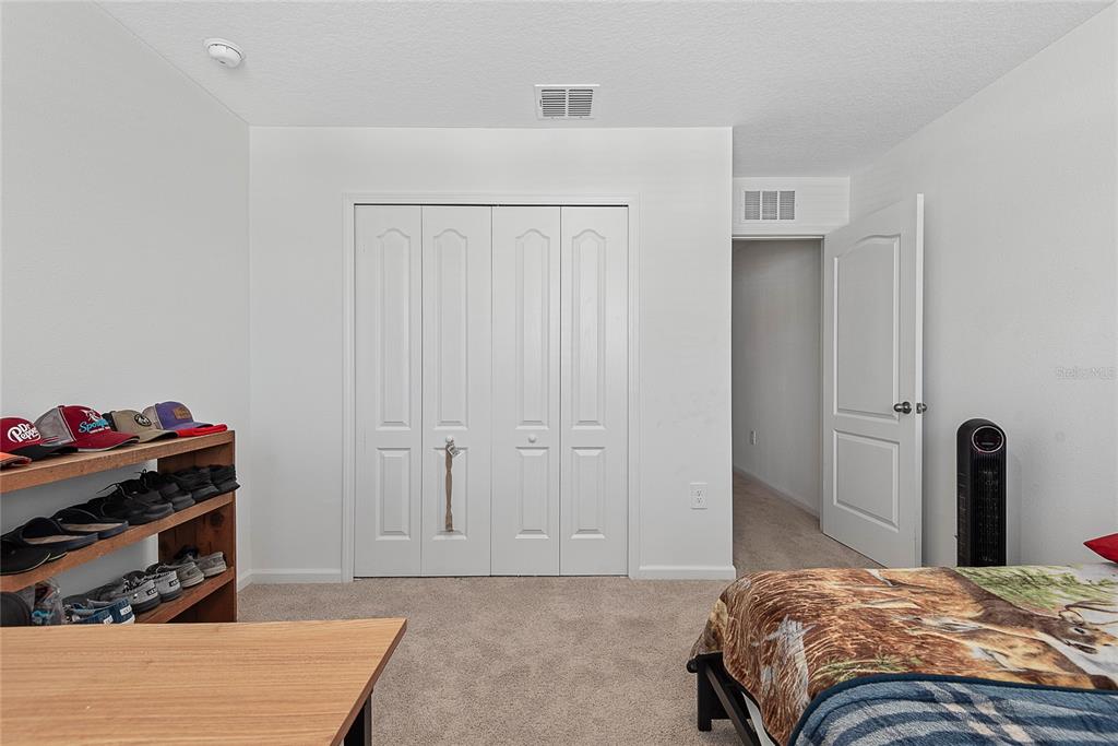 309 Redbud Road Palm Coast, FL 32137 - Photo 28 of 33 a bedroom with a bed and a dresser