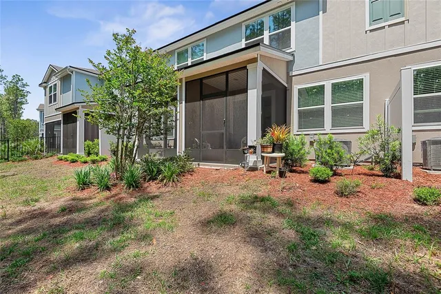 a front view of a house with sitting area and garden