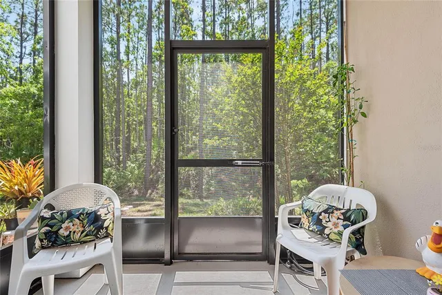 a living room with furniture and a floor to ceiling window
