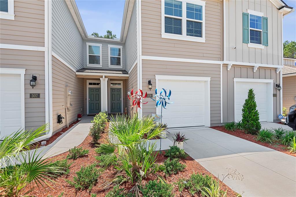 309 Redbud Road Palm Coast, FL 32137 - Photo 6 of 33 a front view of a house with garden