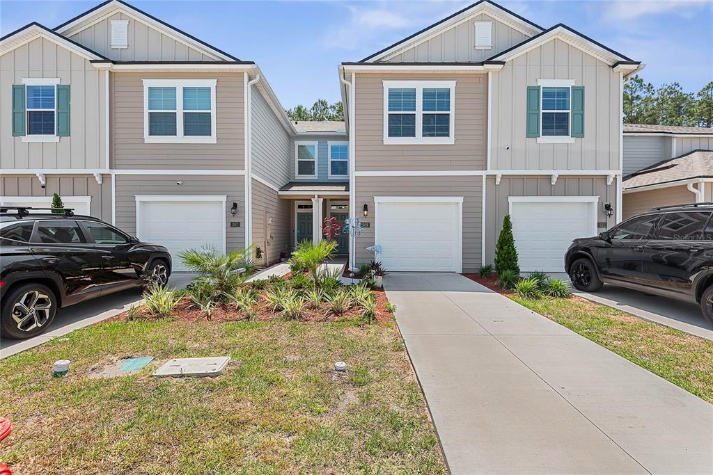 309 Redbud Road Palm Coast, FL 32137 - Photo 7 of 33 a front view of a house with a yard