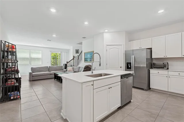 a kitchen with a sink a counter top space and appliances