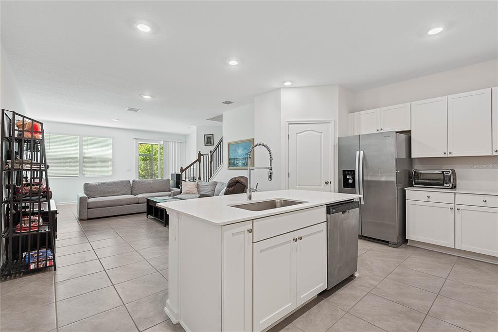 309 Redbud Road Palm Coast, FL 32137 - Photo 9 of 33 a kitchen with a sink a counter top space and appliances