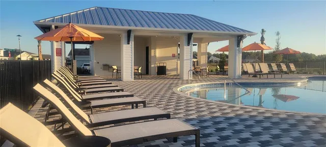 a view of a patio with swimming pool table and chairs