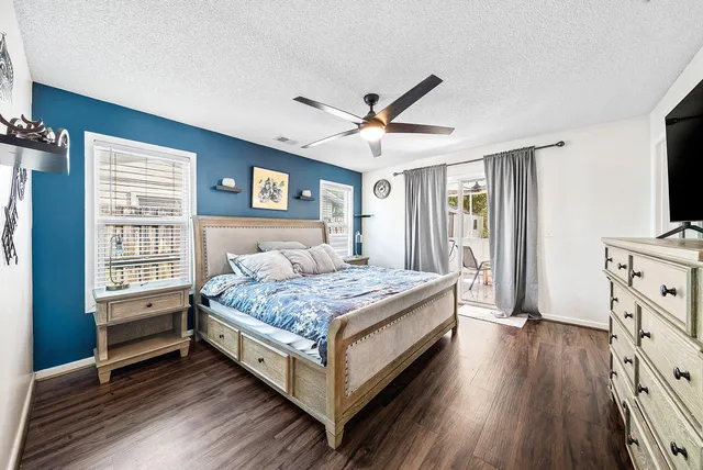 a bedroom with a bed and a flat tv screen on dresser