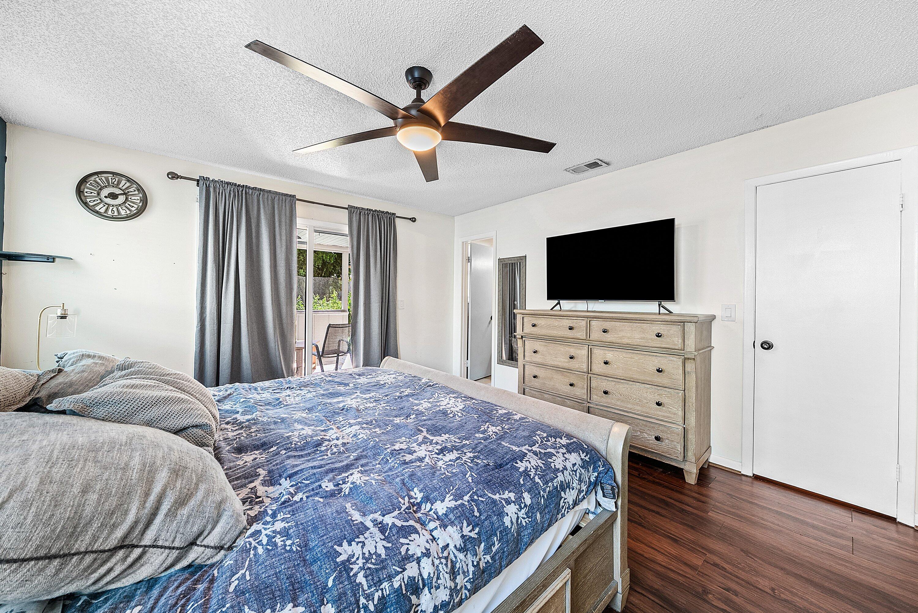 4500 Southeast Salvatori Road Stuart, FL 34997 - Photo 12 of 25 a bedroom with a bed and a flat screen tv